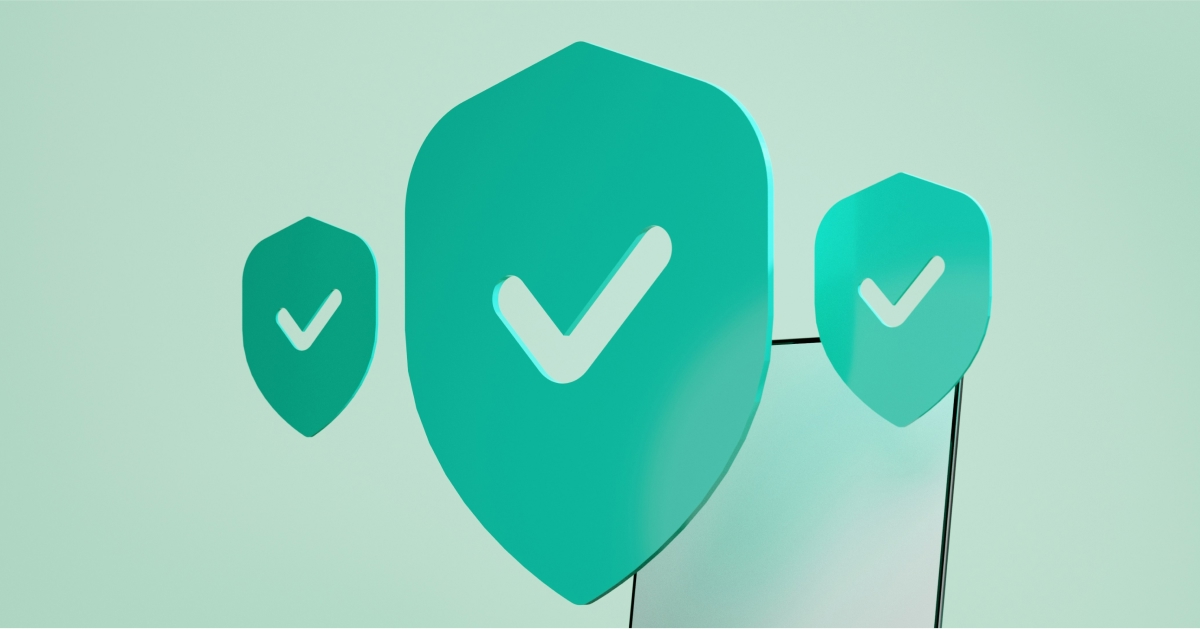 Three green security shields with ticks are floating above a smartphone.